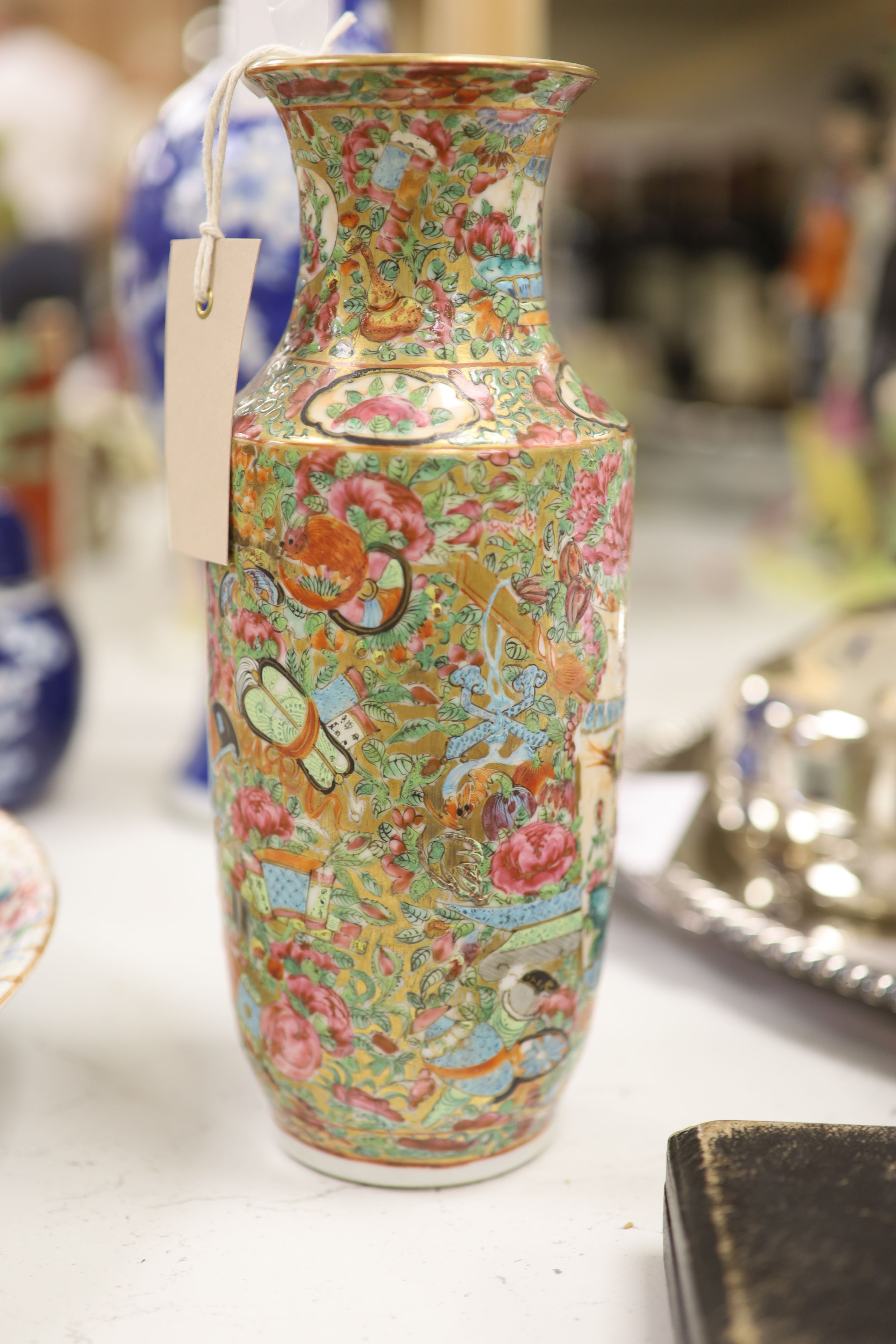 An early 20th century Chinese blue and white ‘prunus’ vase a Republic period millefleur dish, a similar Canton vase and two blue and white jars